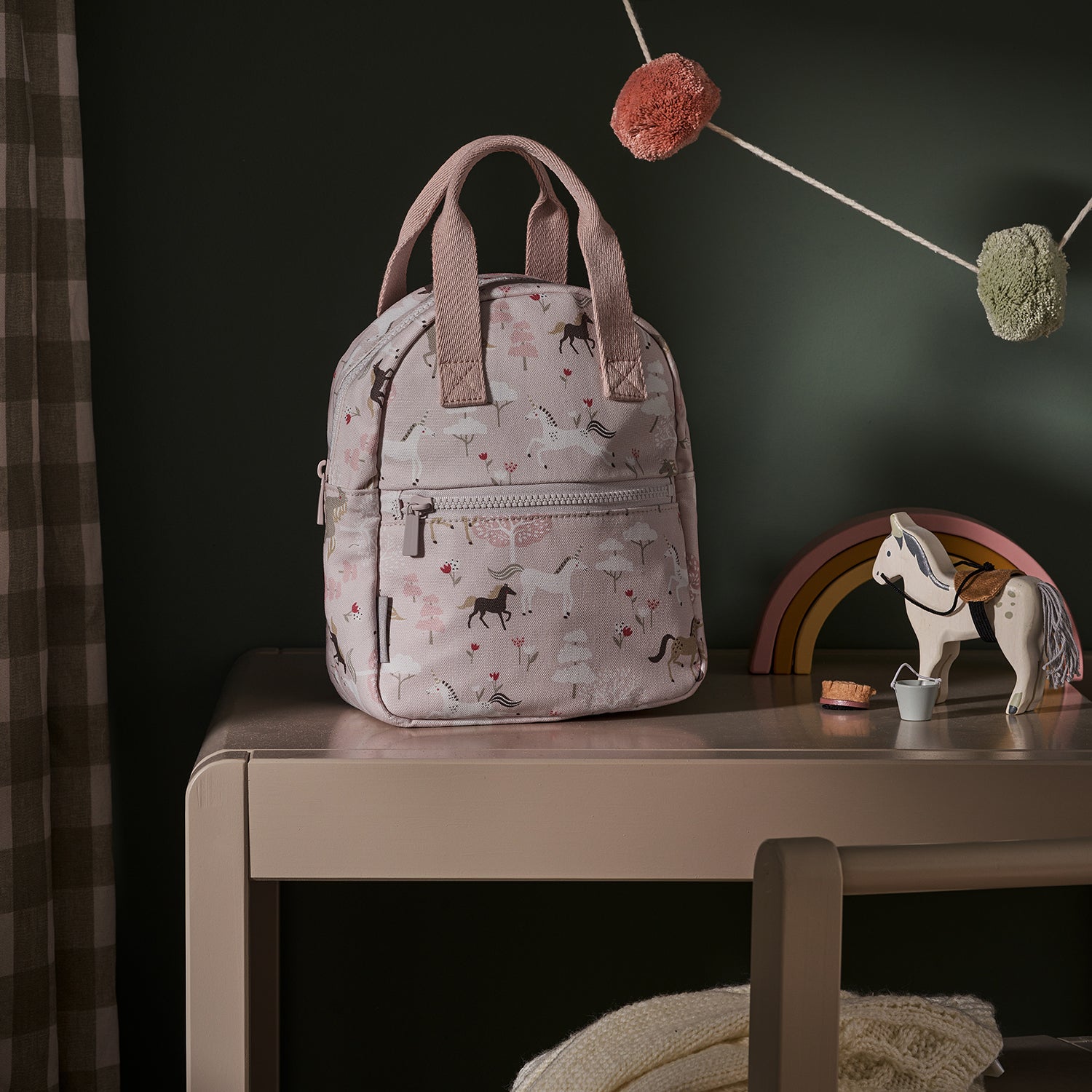 Forest Ponies Backpack by Sophie Allport sat on kids dresser
