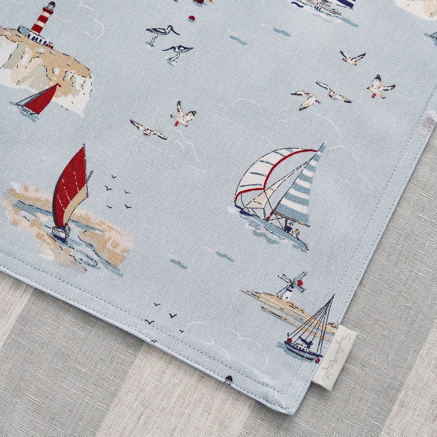Blue fabric placemats with coastal sailing boats print by Sophie Allport detail