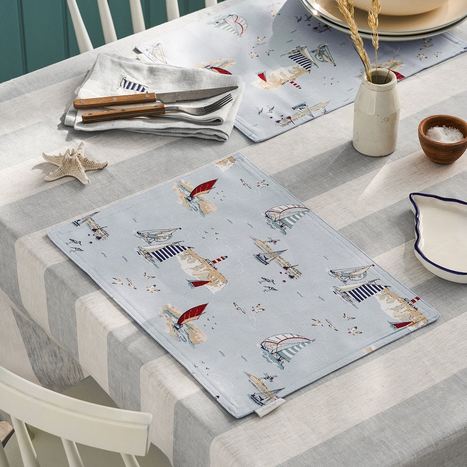 Blue fabric placemats with coastal sailing boats print by Sophie Allport