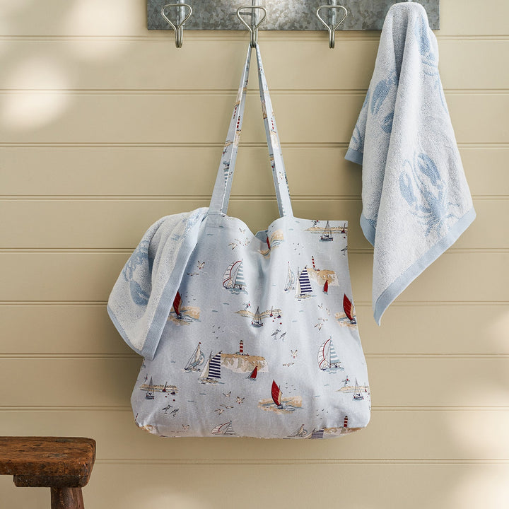 Blue tote bag with coastal sailing boats print by Sophie Allport