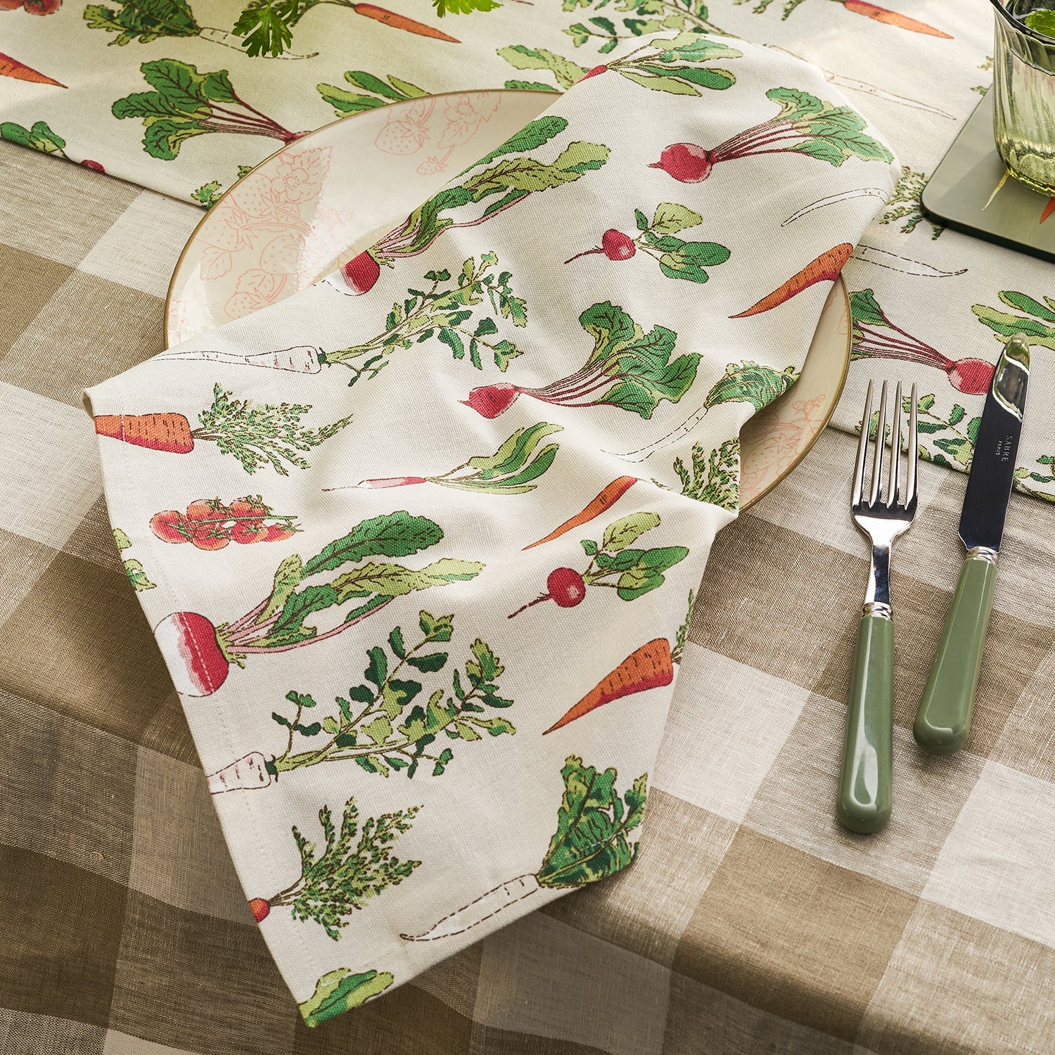 Beige napkins with garden vegetables print by Sophie Allport