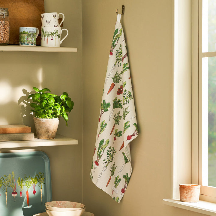 Beige tea towel with garden vegetables print by Sophie Allport