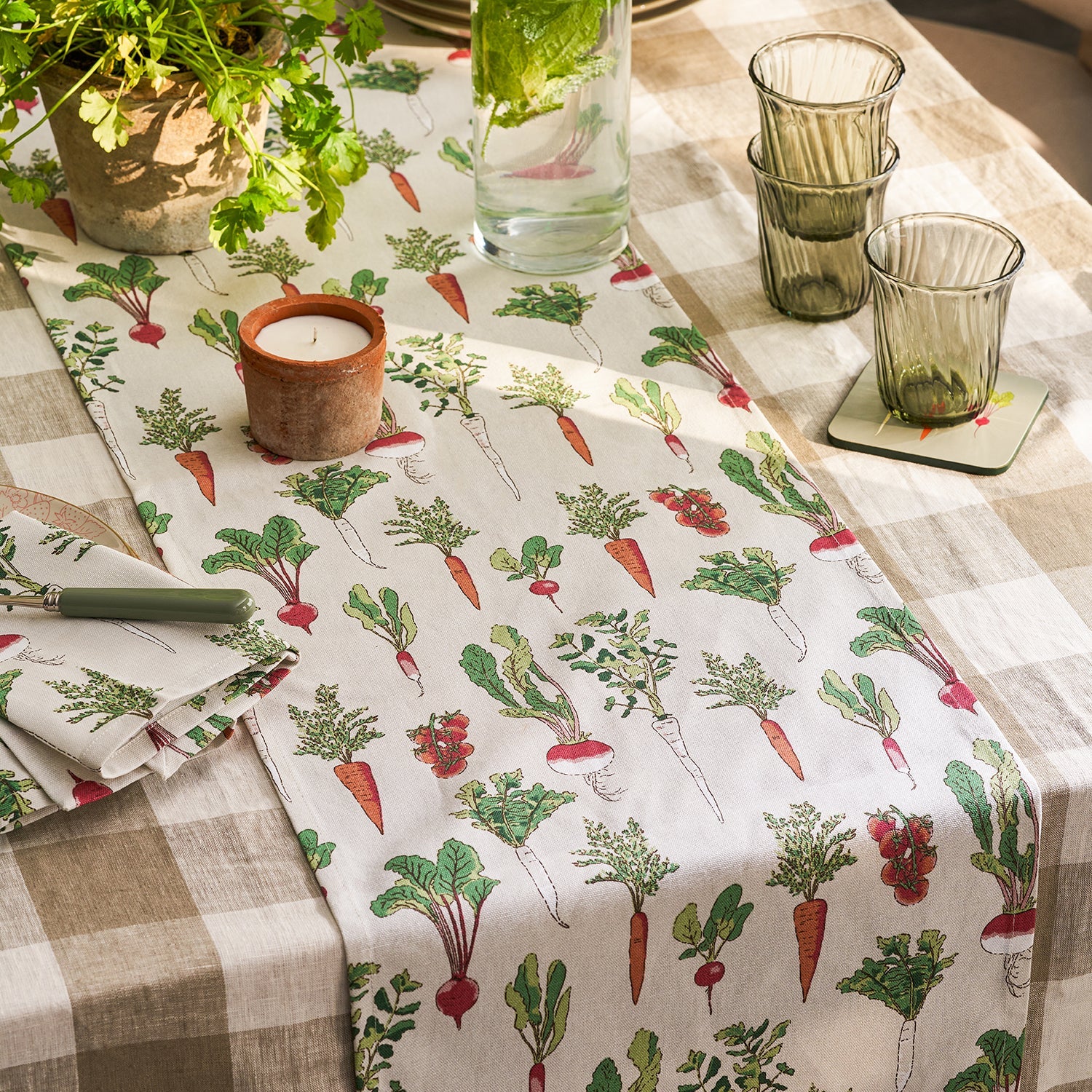 Beige table runner with garden vegetables print by Sophie Allport