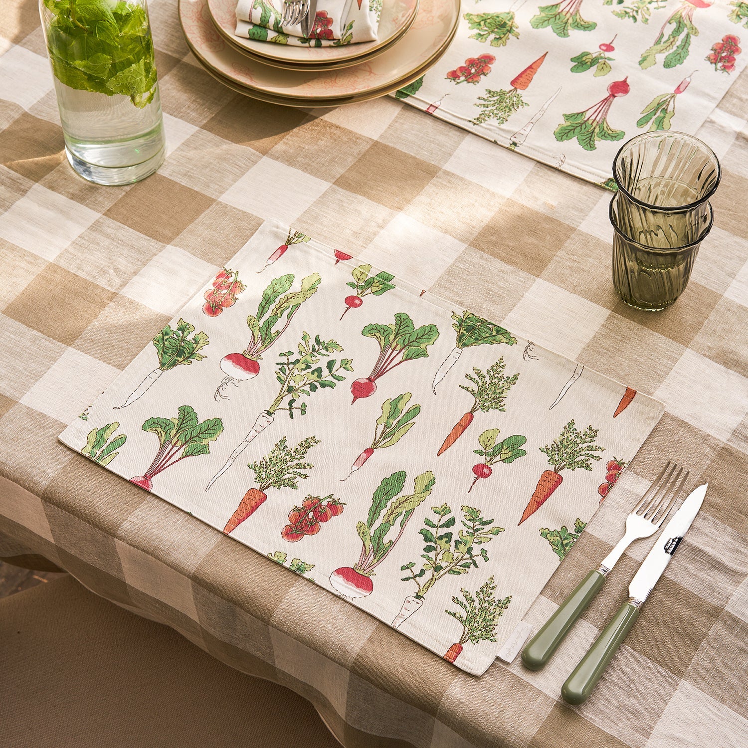 Beige fabric placemats with garden vegetables print by Sophie Allport