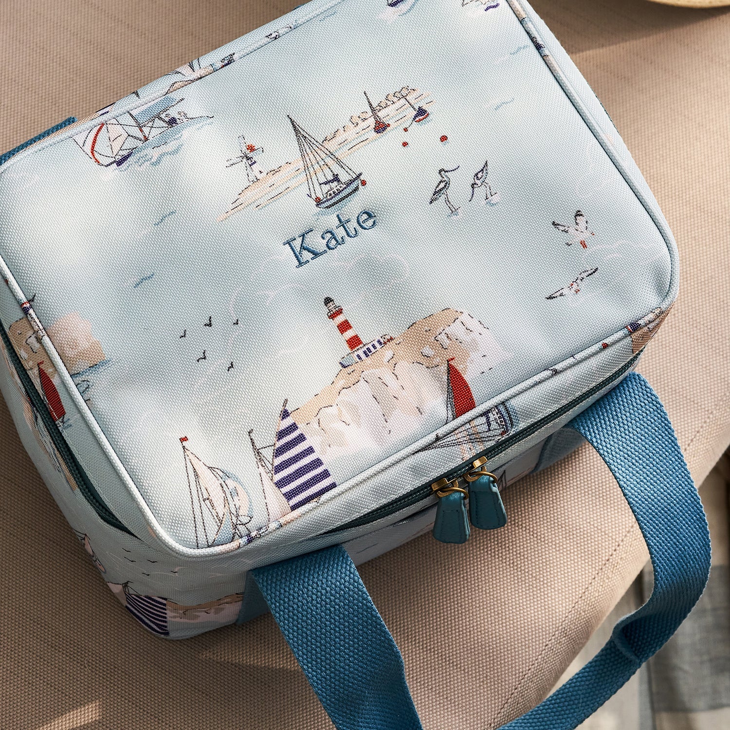 Blue lunch bag with coastal sailing boats print by Sophie Allport personalised detail