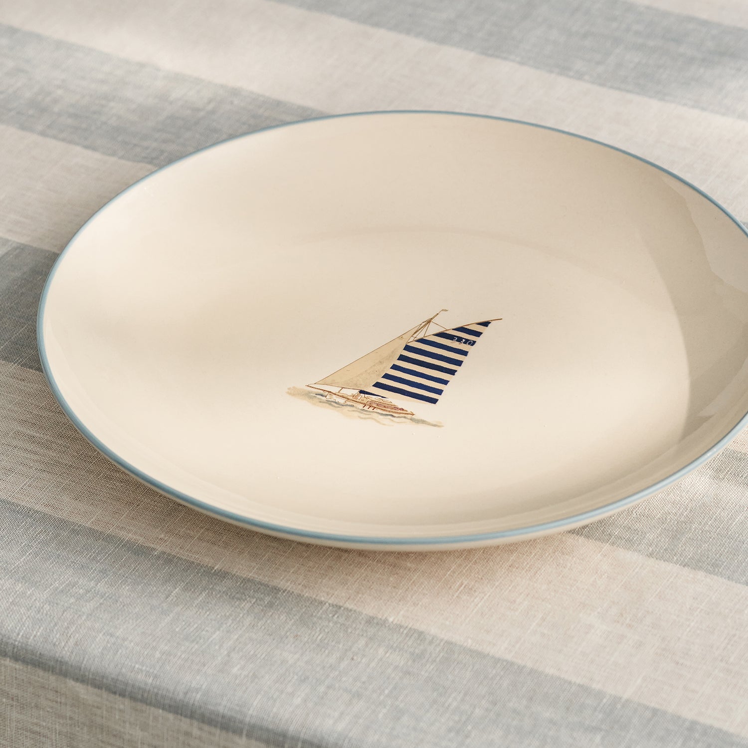 Stoneware dinner plate with blue sailing boat by Sophie Allport detail