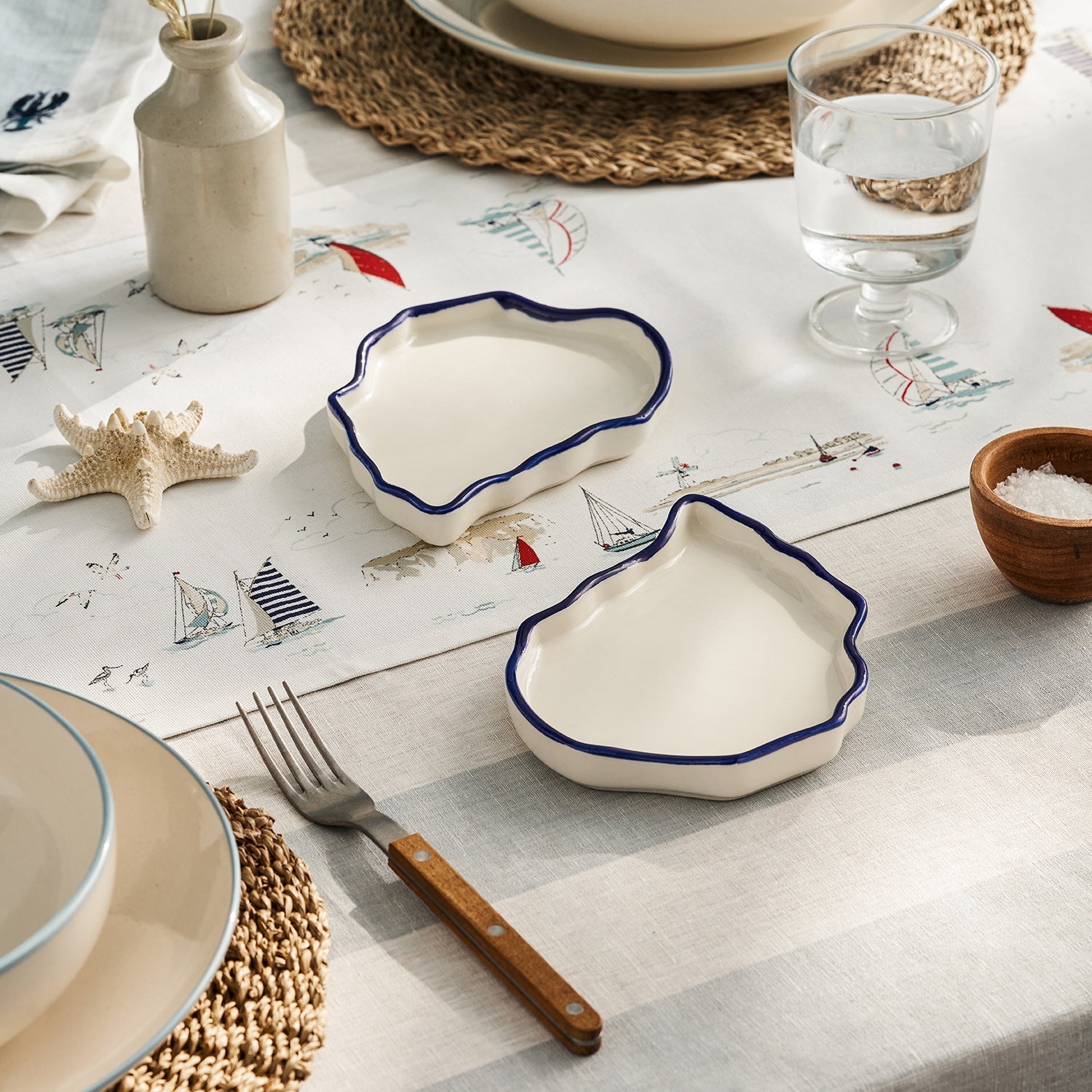 White oyster shape stoneware plates by Sophie Allport