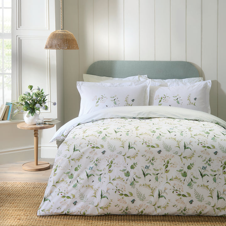 White cotton bedding set with floral print by Sophie Allport bedroom scene