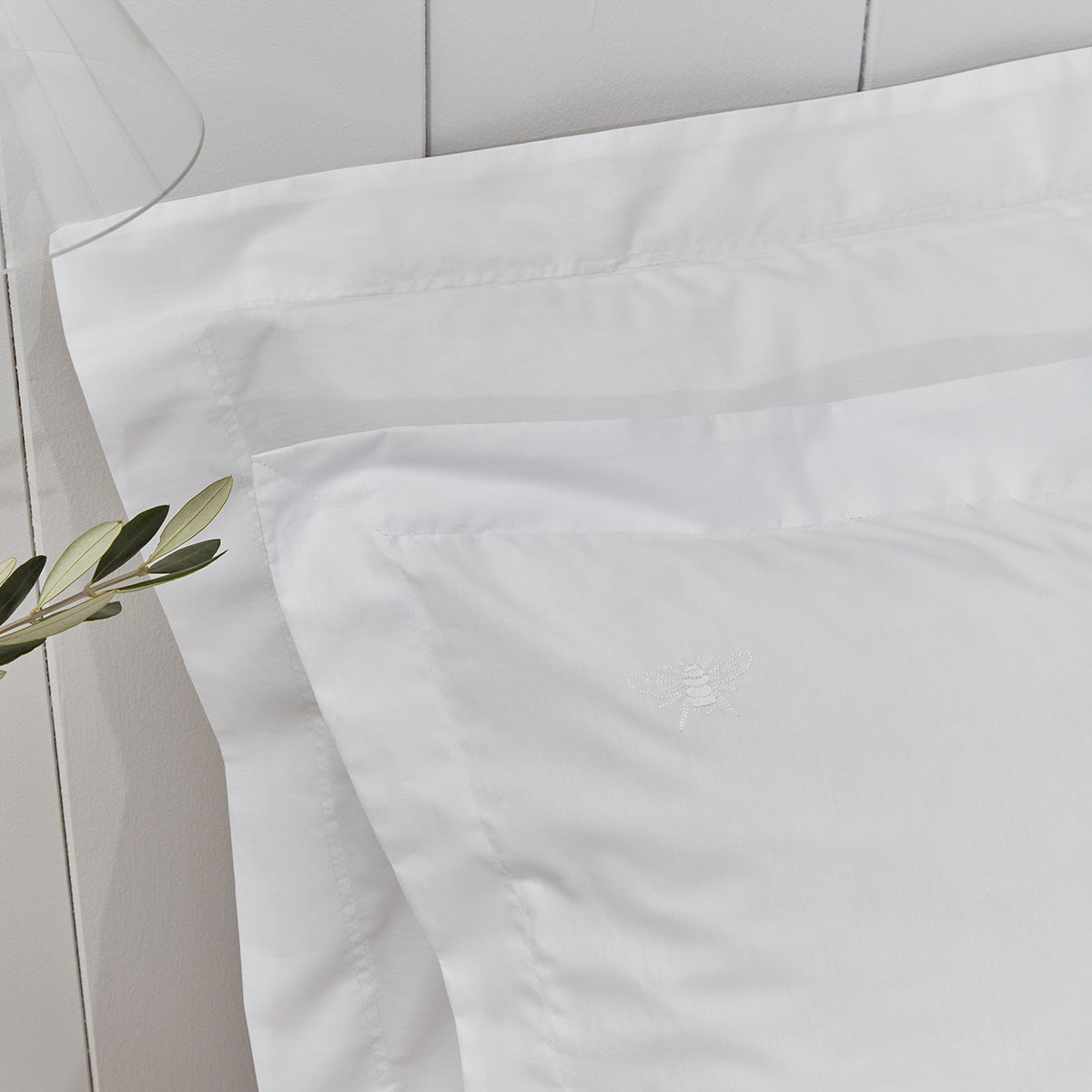 Bee detailing on white pillowcases by Sophie Allport
